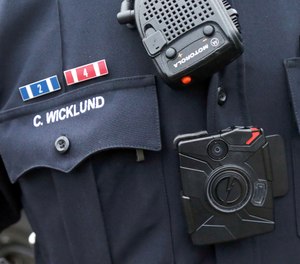 Sgt. Chris Wicklund of the Burnsville Police Department wears a body camera beneath his microphone. Minneapolis, with the largest police department in Minnesota, has become the latest to equip officers with body cameras in what officials say is an effort to improve transparency and police accountability (AP Photo/Jim Mone)